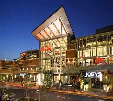 A large, modern shopping mall with a prominent 